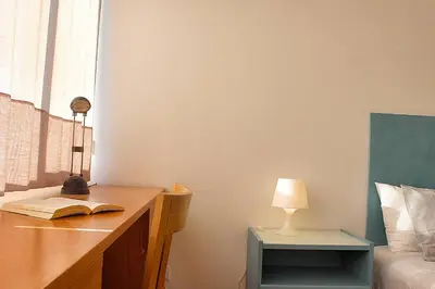 an open book sitting on a table next to a refrigerator at Oporto Early Sunshine Apartment in Porto