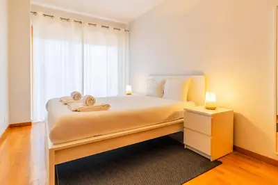 a bedroom with a bed with two towels on it at Casa da Praça in the center of Porto - GuestSPA in Porto
