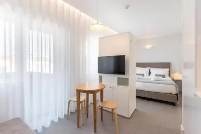 a bedroom with a bed and a table and chairs at Soho Porto in Porto