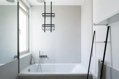 a bathroom with a bath tub and a window at GuestReady - Lux staycation in Boavista in Porto