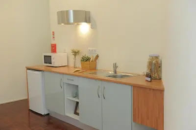a kitchen with a counter with a sink and a microwave at Porto City Center Mercado do Bolhão Prime location jesuína e as 3 janelas in Porto