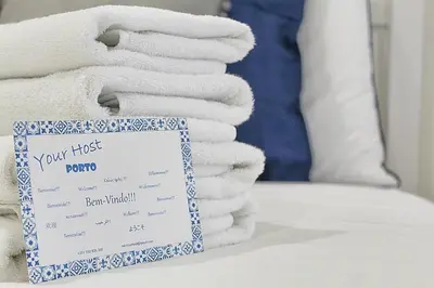 a pile of towels sitting on top of a bed at Oporto Sweet Downtown 2 in Porto