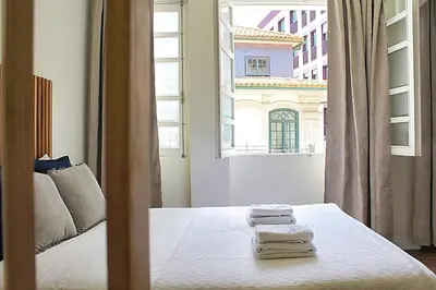 a bedroom with a bed with towels on it at Oporto Sweet Downtown 3 in Porto