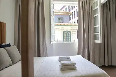 a bedroom with a bed with towels on it at Oporto Sweet Downtown 5 in Porto