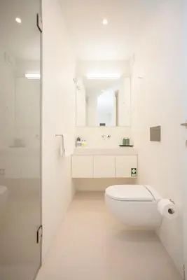 a white bathroom with a toilet and a sink at Liiiving in Porto - Cedofeita Green Terrace in Porto