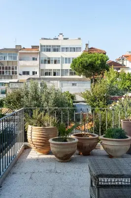 a group of large pots with plants in them on a balcony at Porto Premium Villa in Porto