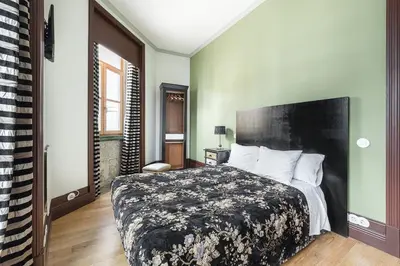 a bedroom with a bed with a black and white comforter at GuestReady - Belle Epoque Apartments in Porto