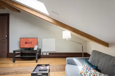 a living room with a couch and a television at GuestReady - Belle Epoque Apartments in Porto