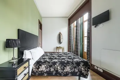 a bedroom with a bed and a flat screen tv at GuestReady - Belle Epoque Apartments in Porto