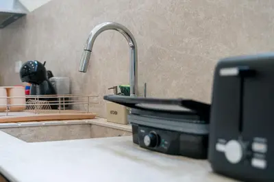 a kitchen counter with a sink and a sink at Porto Hostel Cúpula in Porto