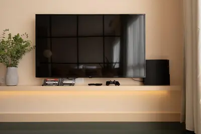 a flat screen tv sitting on a shelf at Stylish Downtown Loft in Porto