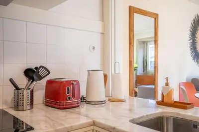 a kitchen with a red toaster on a counter at Historical Downtown Retreat Duplex by LovelyStay in Porto