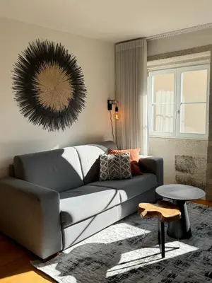 a living room with a couch and a table at Historical Downtown Retreat Duplex by LovelyStay in Porto
