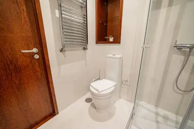 a bathroom with a toilet and a glass shower at Modern Cedofeita by Hosty in Porto