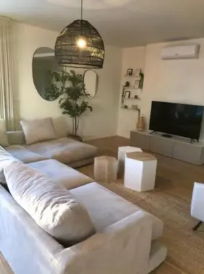 a living room with a couch and a flat screen tv at Amazing Penthouse with a Terrace in Porto