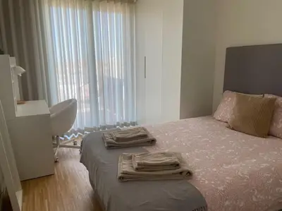 a bedroom with a bed with two towels on it at Amazing Penthouse with a Terrace in Porto