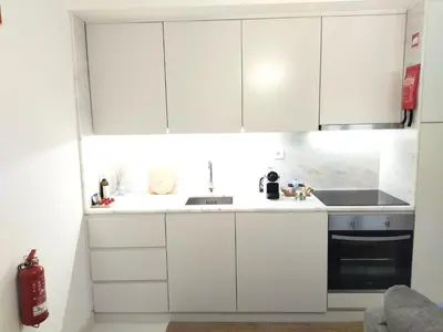 a living room with a couch and a tv and mirrors at Cais das Pedras Pátio Apartment - with washer and dryer machine in Porto