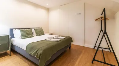 a bedroom with a bed and a tripod at Delightful Duplex by LovelyStay in Porto