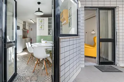 a room with a table and a yellow chair at GuestReady - Porto by Pilar Ridge in Vila Nova de Gaia