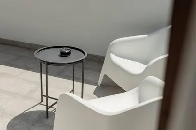 two white chairs and a table with a cup on it at Rooftop Stylish by Hosty in Porto