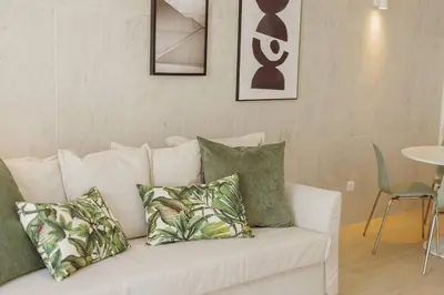 a white couch with pillows on it in a living room at Stylish Apartment With Terrace by Hosty in Porto