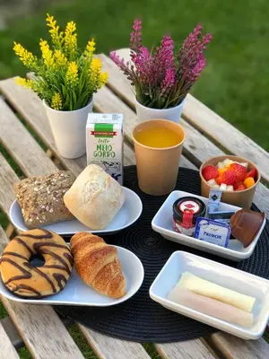 a table with plates of food on a picnic table at Stylish Apartment With Terrace by Hosty in Porto
