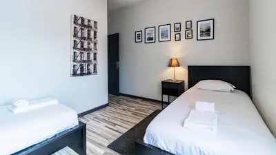a room with two beds and a lamp in it at Abadia by LovelyStay in Porto