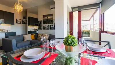 a dining room with a red table and chairs at Abadia by LovelyStay in Porto