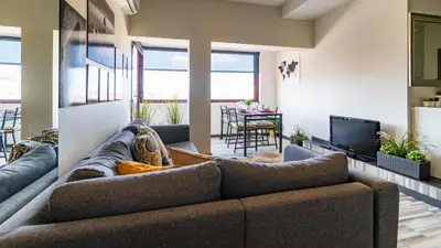 a living room with a couch and a television at Abadia by LovelyStay in Porto