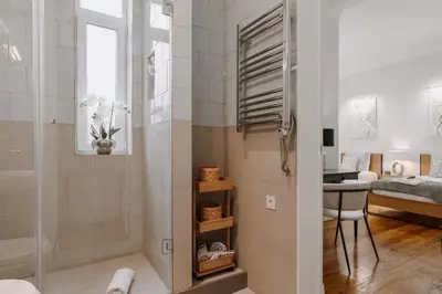 a bathroom with a shower and a desk and a bedroom at Romantic Luxury House w Captivating Outdoor Patio in Porto