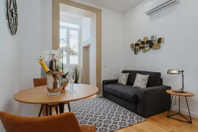 a living room with a table and a couch at Exclusive Charm House in Porto