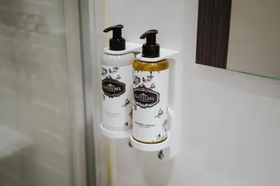 two bottles of disinfectants are hanging on a door at Exclusive Charm House in Porto
