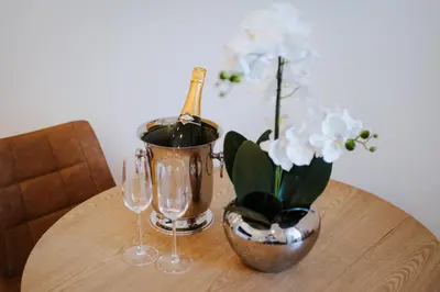 a table with a bottle of wine and two glasses at Exclusive Charm House in Porto