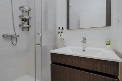 a bathroom with a sink and a shower at Exclusive Charm House in Porto