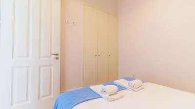a bedroom with a bed with towels on it at Duque Flat - AC & Balcony by LovelyStay in Porto