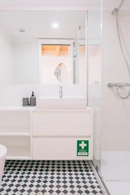 a white bathroom with a sink and a shower at ORM - Cedofeita I Apartment in Porto