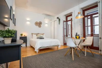 a bedroom with a bed and a table and chairs at Host Wise - Peaceful Amazing Apartment - Ace Location in Porto