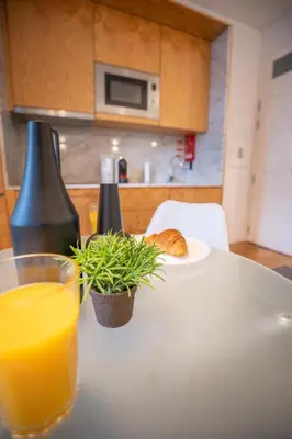 a table with a glass of orange juice and a plate of bread at Host Wise - Peaceful Amazing Apartment - Ace Location in Porto