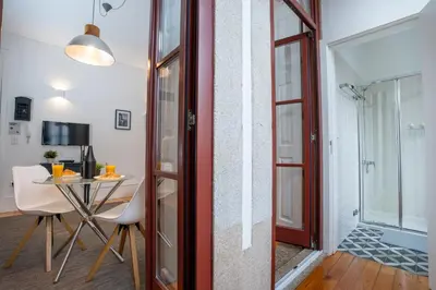 a room with a table and a glass door at Host Wise - Peaceful Amazing Apartment - Ace Location in Porto
