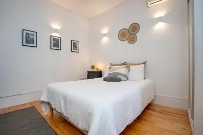 a white bedroom with a large white bed in it at Host Wise - Peaceful Amazing Apartment - Ace Location in Porto