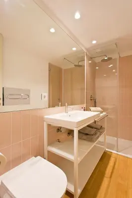 a bathroom with a sink and a mirror at Ateneu Boutique Townhouse Bolhão in Porto