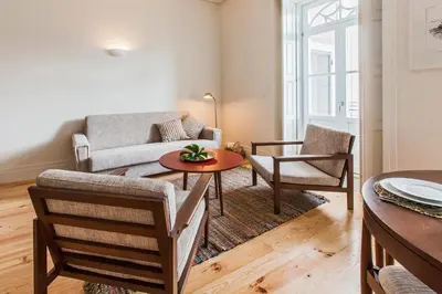 a living room with a couch and a table and chairs at bnapartments Loftpuzzle in Porto