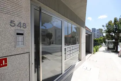 a building with large glass windows on the side of it at FLH Boavista Wooden Flats in Porto