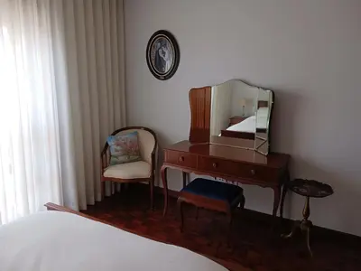 a bedroom with a desk with a mirror and a chair at Portus Cale by LovelyStay in Vila Nova de Gaia