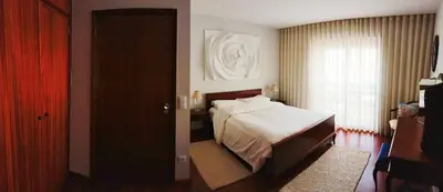 a bedroom with a bed and a window and a door at Portus Cale by LovelyStay in Vila Nova de Gaia