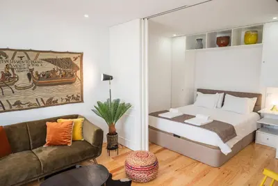a bedroom with a bed and a couch at Patio de Flores in Porto