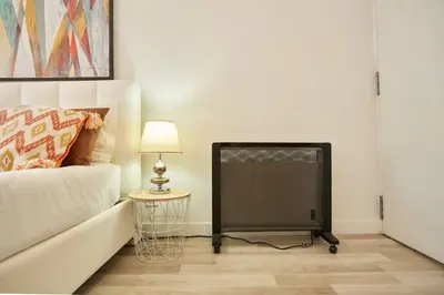 a television in a room with a bed and a lamp at So Simply Ribeira in Porto