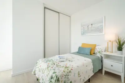 a white bedroom with a bed and a white cabinet at Host Wise - Peaceful Sunny Flat - Ace Location in Porto
