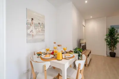 a white dining room with a white table and chairs at Host Wise - Peaceful Sunny Flat - Ace Location in Porto