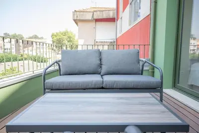 a couch sitting on a balcony next to a window at Truly Porto in Porto